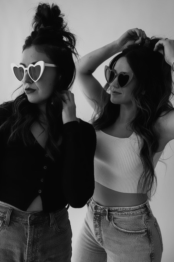 Em and Lu posing in heart sunglasses